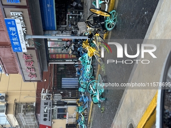 Shared bicycles are blown down during heavy winds and rain as Typhoon Bebika makes landfall in Shanghai, China, on September 16, 2024. (