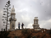 Palestinians stand inside a cemetery in the Nuseirat refugee camp in the central Gaza Strip, on September 16, 2024, amid the ongoing war bet...