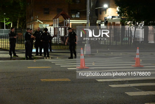 Police place evidence markers and set up crime scene tape at the scene where two people are shot. Two people are shot in Brooklyn, New York,...