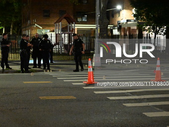 Police place evidence markers and set up crime scene tape at the scene where two people are shot. Two people are shot in Brooklyn, New York,...