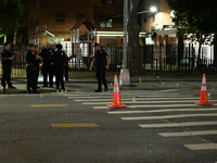 Police place evidence markers and set up crime scene tape at the scene where two people are shot. Two people are shot in Brooklyn, New York,...