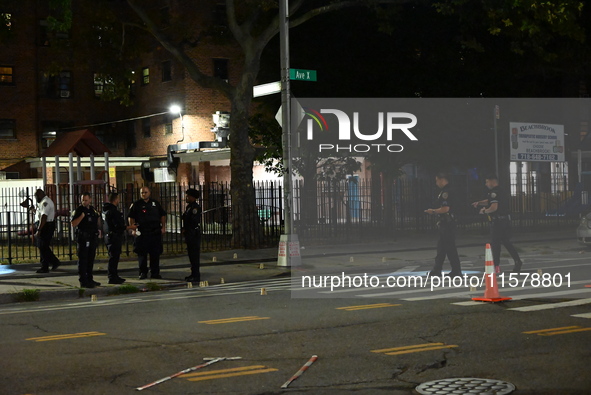 Police place evidence markers and set up crime scene tape at the scene where two people are shot. Two people are shot in Brooklyn, New York,...