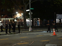 Police place evidence markers and set up crime scene tape at the scene where two people are shot. Two people are shot in Brooklyn, New York,...