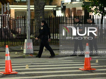 Police place evidence markers and set up crime scene tape at the scene where two people are shot. Two people are shot in Brooklyn, New York,...