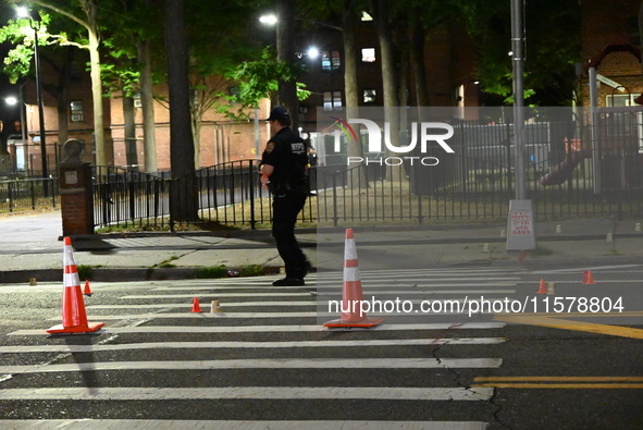 Police place evidence markers and set up crime scene tape at the scene where two people are shot. Two people are shot in Brooklyn, New York,...