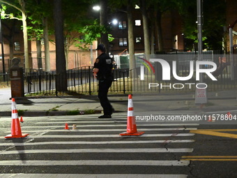 Police place evidence markers and set up crime scene tape at the scene where two people are shot. Two people are shot in Brooklyn, New York,...