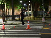 Police place evidence markers and set up crime scene tape at the scene where two people are shot. Two people are shot in Brooklyn, New York,...