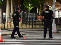 Police place evidence markers and set up crime scene tape at the scene where two people are shot. Two people are shot in Brooklyn, New York,...