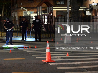 Police place evidence markers and set up crime scene tape at the scene where two people are shot. Two people are shot in Brooklyn, New York,...