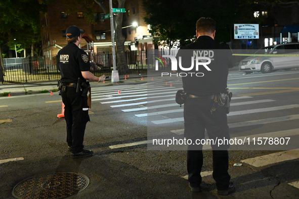 Police place evidence markers and set up crime scene tape at the scene where two people are shot. Two people are shot in Brooklyn, New York,...