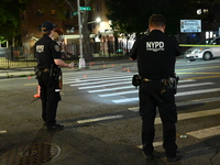 Police place evidence markers and set up crime scene tape at the scene where two people are shot. Two people are shot in Brooklyn, New York,...