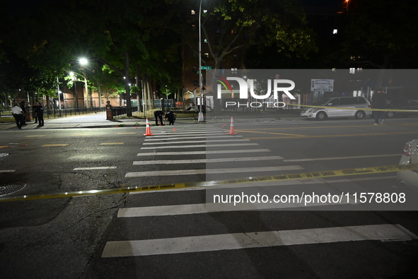 Police place evidence markers and set up crime scene tape at the scene where two people are shot. Two people are shot in Brooklyn, New York,...