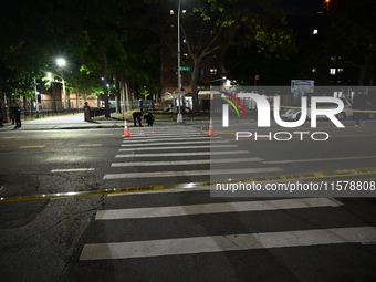 Police place evidence markers and set up crime scene tape at the scene where two people are shot. Two people are shot in Brooklyn, New York,...