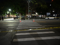 Police place evidence markers and set up crime scene tape at the scene where two people are shot. Two people are shot in Brooklyn, New York,...