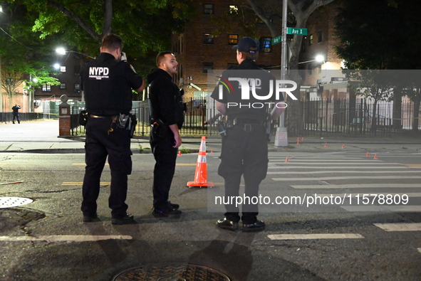 Police place evidence markers and set up crime scene tape at the scene where two people are shot. Two people are shot in Brooklyn, New York,...