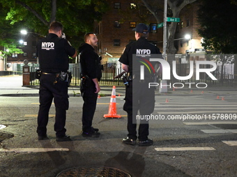 Police place evidence markers and set up crime scene tape at the scene where two people are shot. Two people are shot in Brooklyn, New York,...