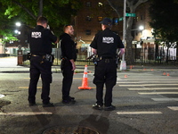 Police place evidence markers and set up crime scene tape at the scene where two people are shot. Two people are shot in Brooklyn, New York,...