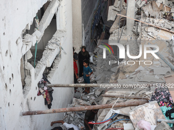 Palestinians inspect a house hit in an Israeli strike in Nuseirat, Gaza Strip, on September 16, 2024, amid the ongoing war between Israel an...