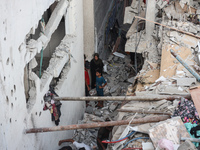 Palestinians inspect a house hit in an Israeli strike in Nuseirat, Gaza Strip, on September 16, 2024, amid the ongoing war between Israel an...