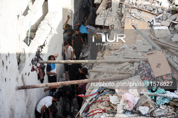 Palestinians inspect a house hit in an Israeli strike in Nuseirat, Gaza Strip, on September 16, 2024, amid the ongoing war between Israel an...