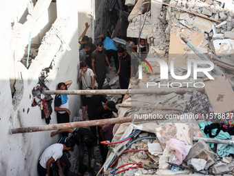 Palestinians inspect a house hit in an Israeli strike in Nuseirat, Gaza Strip, on September 16, 2024, amid the ongoing war between Israel an...