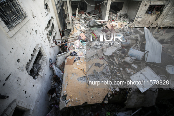 Palestinians inspect a house hit in an Israeli strike in Nuseirat, Gaza Strip, on September 16, 2024, amid the ongoing war between Israel an...