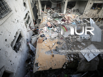 Palestinians inspect a house hit in an Israeli strike in Nuseirat, Gaza Strip, on September 16, 2024, amid the ongoing war between Israel an...