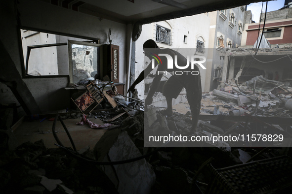 A Palestinian man inspects his home, which is damaged by an Israeli airstrike on a house in Nuseirat, central Gaza Strip, on September 16, 2...