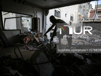 A Palestinian man inspects his home, which is damaged by an Israeli airstrike on a house in Nuseirat, central Gaza Strip, on September 16, 2...