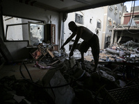 A Palestinian man inspects his home, which is damaged by an Israeli airstrike on a house in Nuseirat, central Gaza Strip, on September 16, 2...