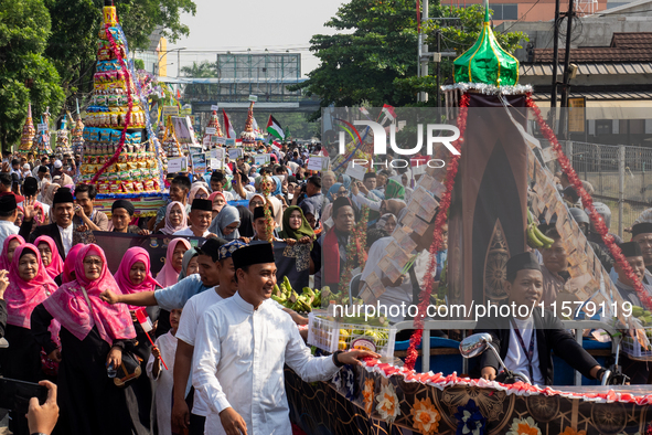 Hundreds of Muslims participate in the boat procession tradition, known as 'Kirab Perahu,' during the Prophet Muhammad's birthday celebratio...