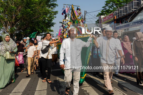 Hundreds of Muslims participate in the boat procession tradition, known as 'Kirab Perahu,' during the Prophet Muhammad's birthday celebratio...