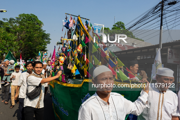 Hundreds of Muslims participate in the boat procession tradition, known as 'Kirab Perahu,' during the Prophet Muhammad's birthday celebratio...