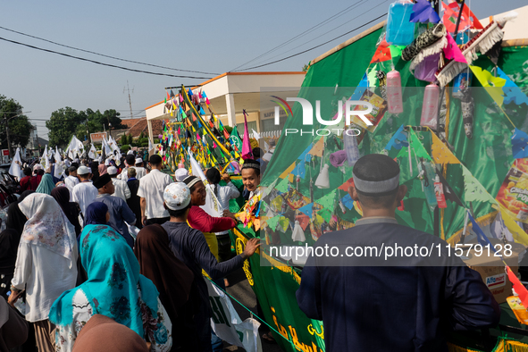 Hundreds of Muslims participate in the boat procession tradition, known as 'Kirab Perahu,' during the Prophet Muhammad's birthday celebratio...