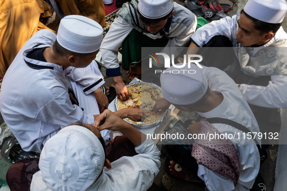 Muslims eat kebuli rice during the Prophet Muhammad's birthday celebration in Tangerang, Banten Province, Indonesia, on September 16, 2024....