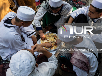 Muslims eat kebuli rice during the Prophet Muhammad's birthday celebration in Tangerang, Banten Province, Indonesia, on September 16, 2024....