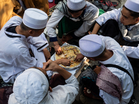 Muslims eat kebuli rice during the Prophet Muhammad's birthday celebration in Tangerang, Banten Province, Indonesia, on September 16, 2024....