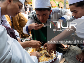 Muslims eat kebuli rice during the Prophet Muhammad's birthday celebration in Tangerang, Banten Province, Indonesia, on September 16, 2024....