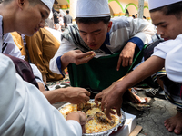 Muslims eat kebuli rice during the Prophet Muhammad's birthday celebration in Tangerang, Banten Province, Indonesia, on September 16, 2024....