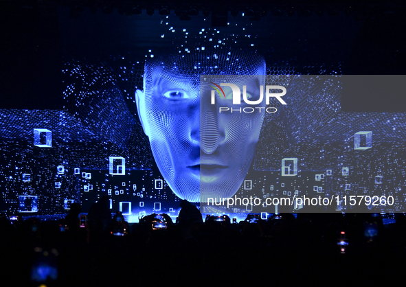 People look at display screens during the opening of the ConteQ Expo24 (Advanced Technology for Construction & Services Expo) at the Qatar N...