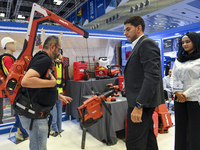 People watch the performance at the Hilti Pavilion during ConteQ Expo24 (Advanced Technology for Construction & Services Expo) at the Qatar...