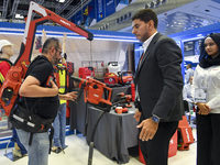 People watch the performance at the Hilti Pavilion during ConteQ Expo24 (Advanced Technology for Construction & Services Expo) at the Qatar...