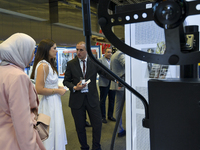 People visit the Traffic Tech booth during ConteQ Expo24 (Advanced Technology for Construction & Services Expo) at the Qatar National Conven...