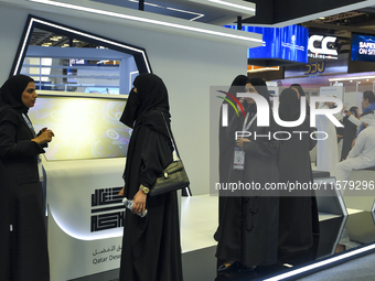 People visit the Qatar Public Works Authority booth during ConteQ Expo24 (Advanced Technology for Construction & Services Expo) at the Qatar...