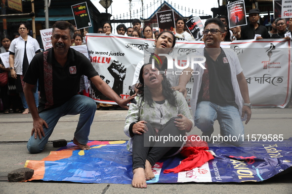 Artists perform a street play during a teachers' protest against the rape and murder of a PGT woman doctor at the government-run R G Kar Med...