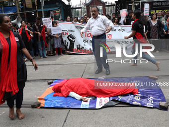 Artists perform a street play during a teachers' protest against the rape and murder of a PGT woman doctor at the government-run R G Kar Med...