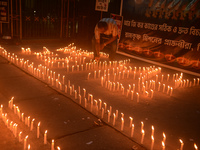 Former students of Ramkrishna Mission light candles as they take part in a protest to condemn the rape and murder of a young medic at RG Kar...