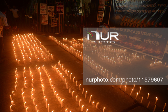 Former students of Ramkrishna Mission light candles as they take part in a protest to condemn the rape and murder of a young medic at RG Kar...