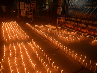 Former students of Ramkrishna Mission light candles as they take part in a protest to condemn the rape and murder of a young medic at RG Kar...