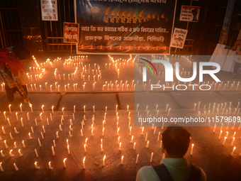 Former students of Ramkrishna Mission light candles as they take part in a protest to condemn the rape and murder of a young medic at RG Kar...